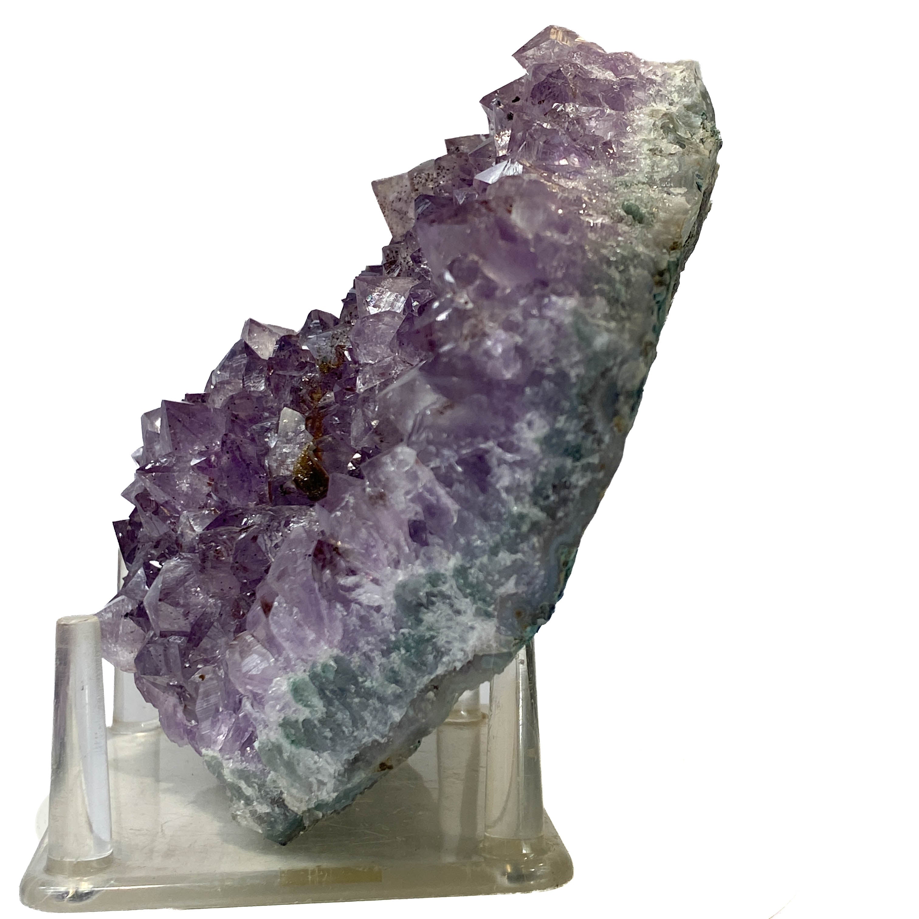 Rich amethyst cluster from South America with cacoxenite inclusions on white background