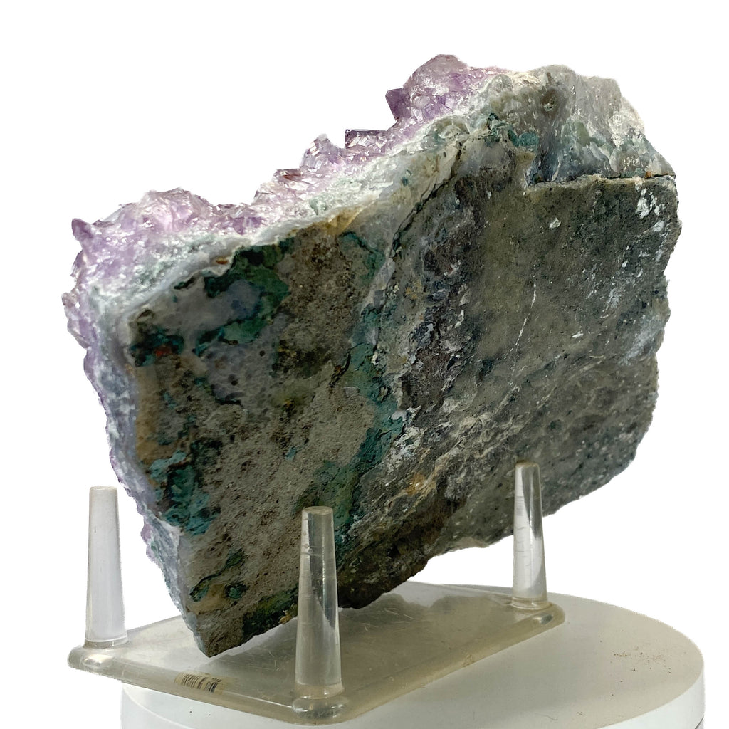 Rich amethyst cluster from South America with cacoxenite inclusions on white background