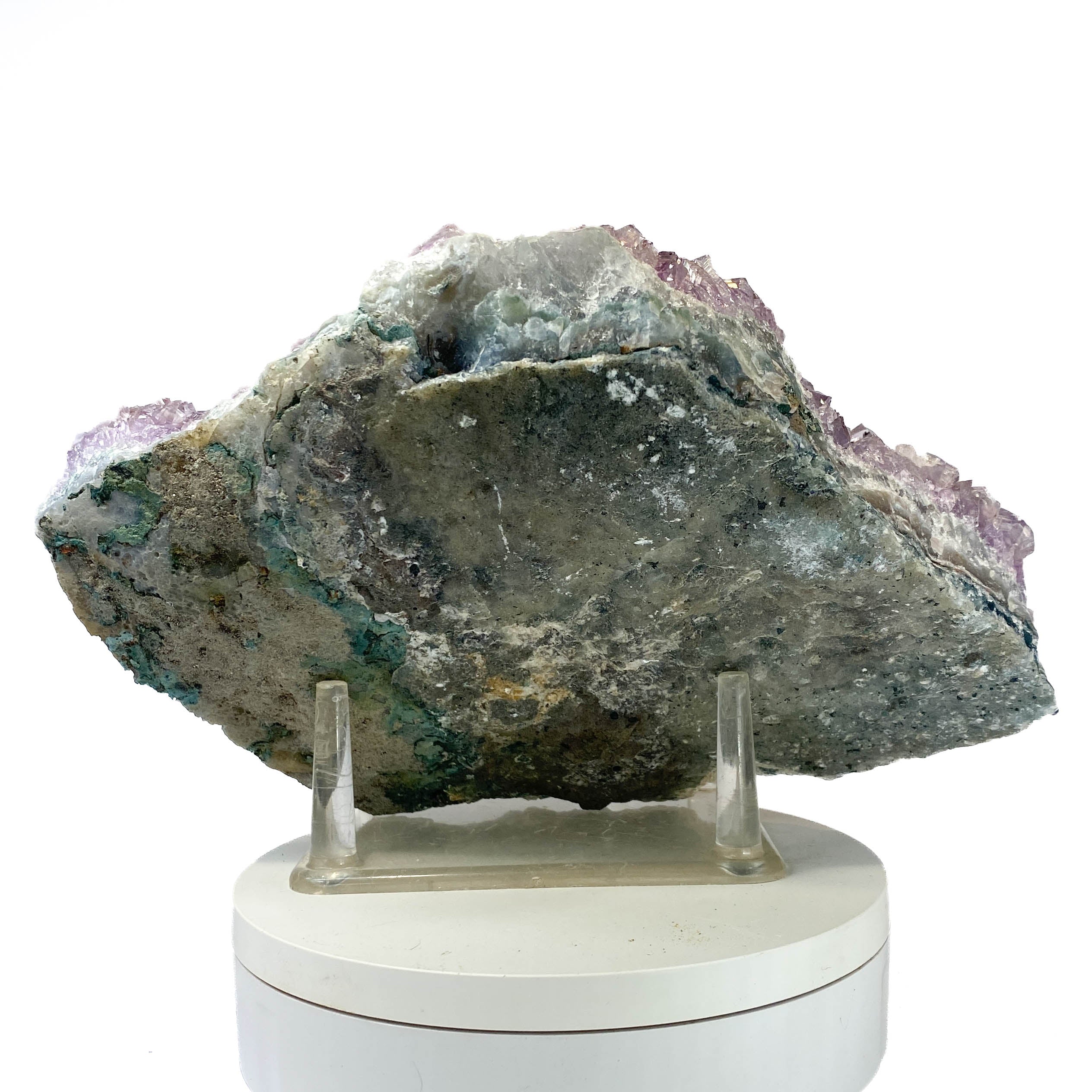 Rich amethyst cluster from South America with cacoxenite inclusions on white background