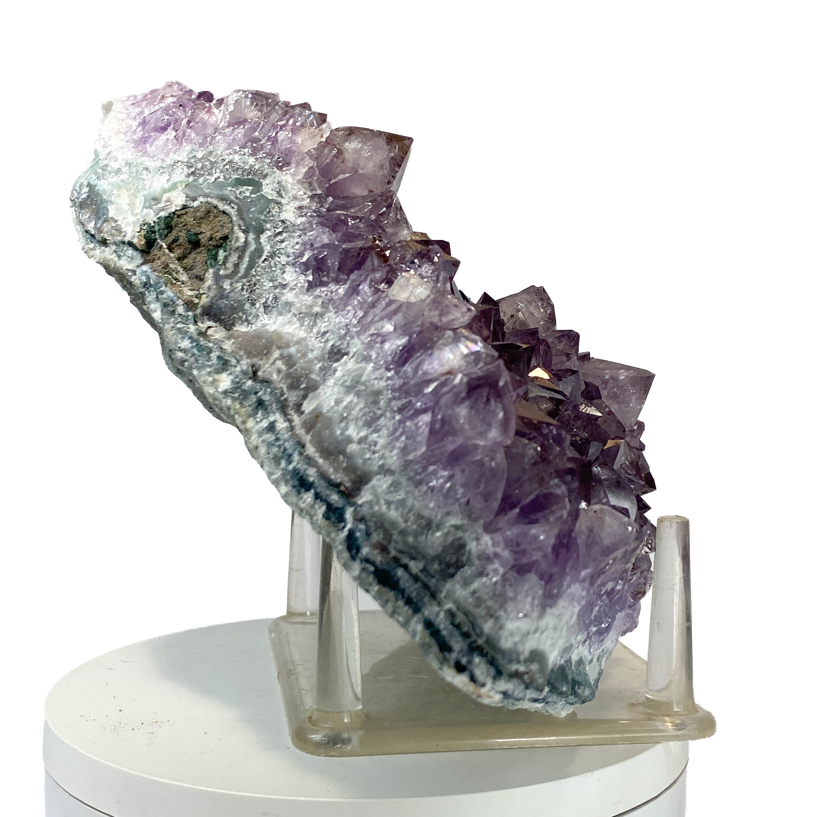Rich amethyst cluster from South America with cacoxenite inclusions on white background
