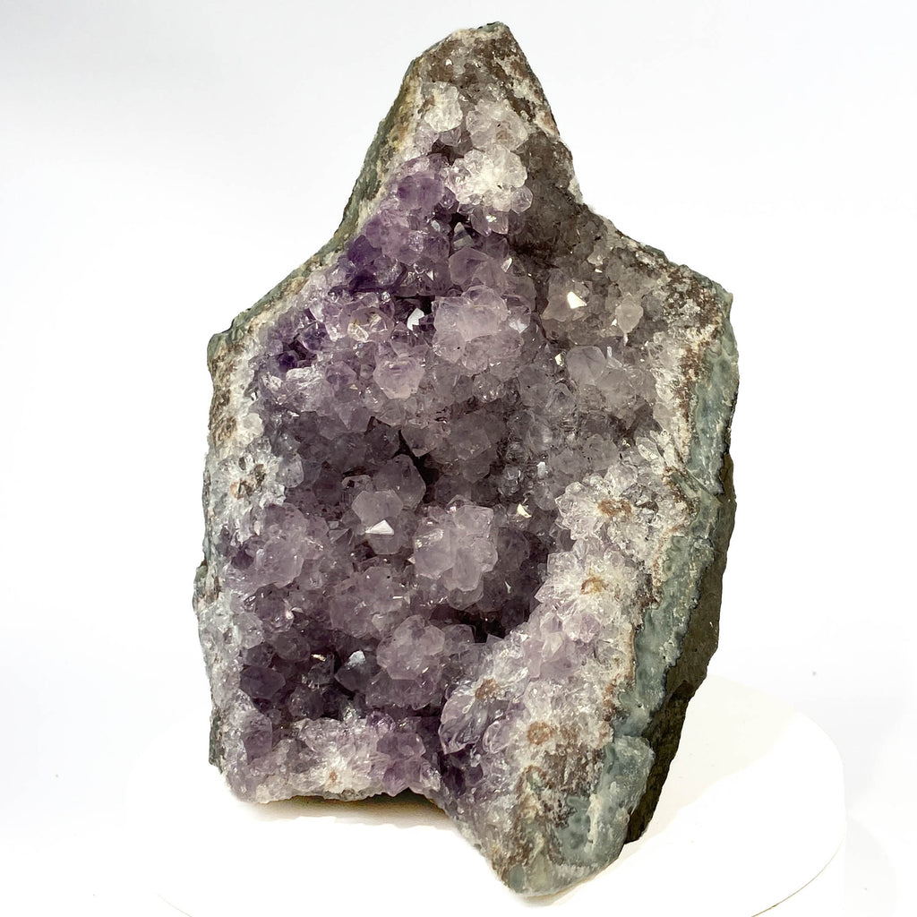 Uruguay amethyst geode with stalactite bumps and lavender crystal flowers