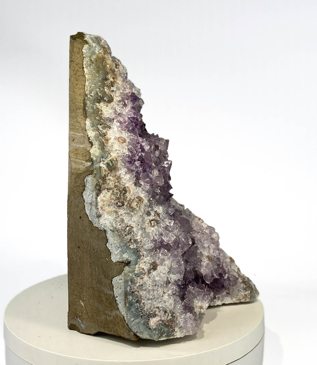 Uruguay amethyst geode with stalactite bumps and lavender crystal flowers