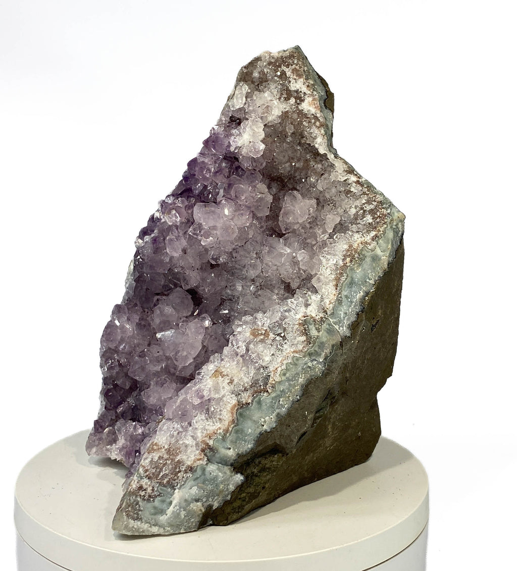 Uruguay amethyst geode with stalactite bumps and lavender crystal flowers