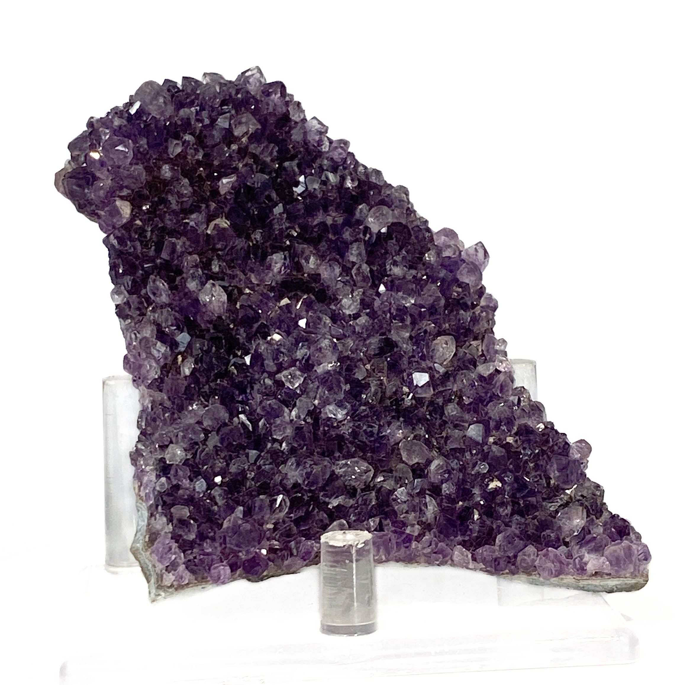 Dark purple amethyst cluster with fine crystal points on white background