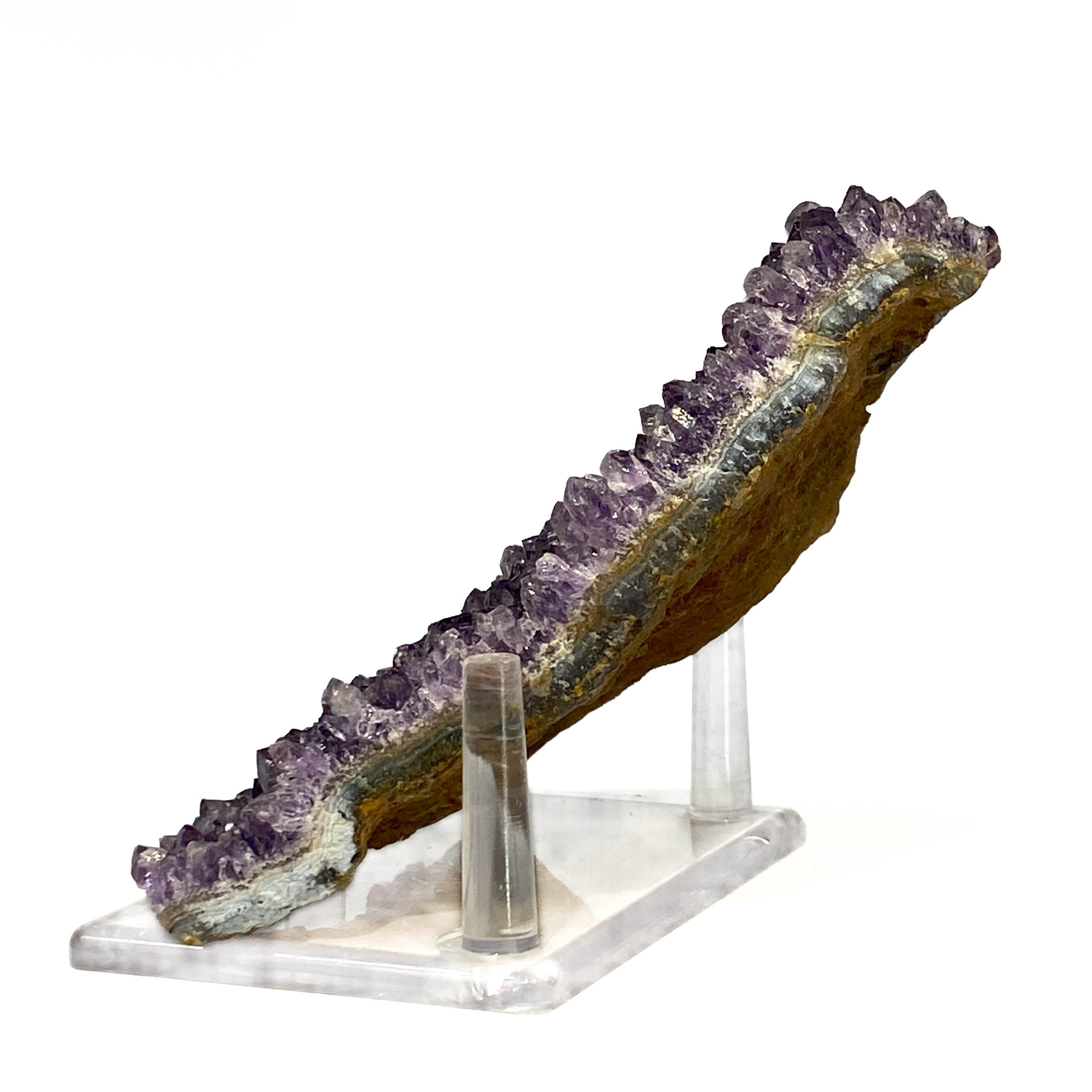 Dark purple amethyst cluster with fine crystal points on white background