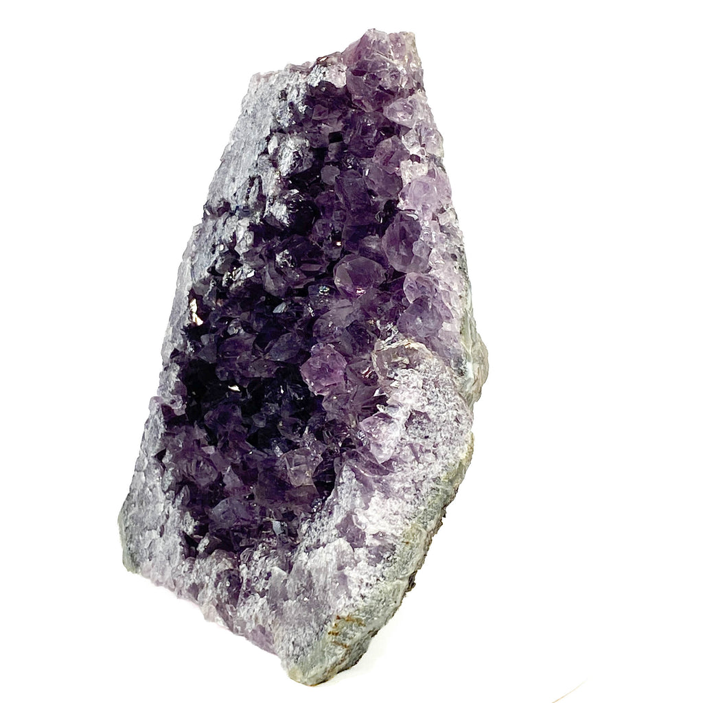 Dark purple amethyst cluster with cross-cut crystal faces on white background