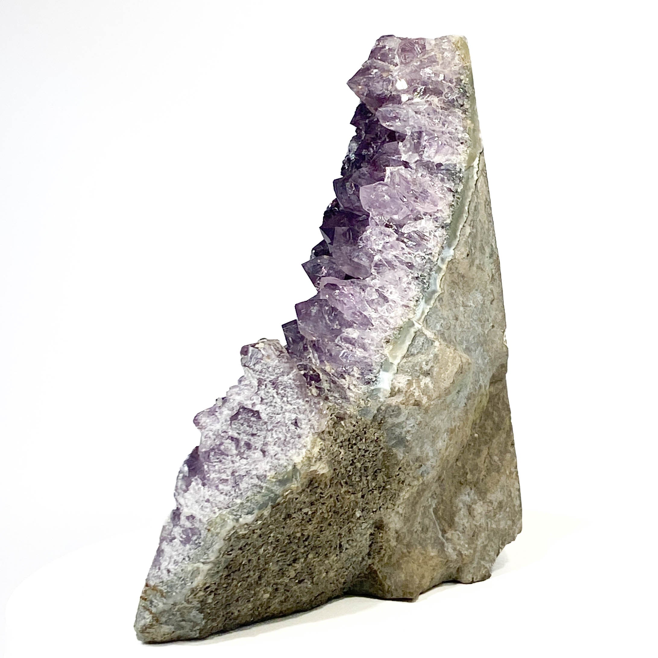 Dark purple amethyst cluster with cross-cut crystal faces on white background