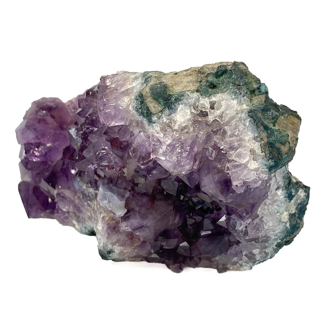 Dark amethyst horizontal standing cluster with small stalactites on white background