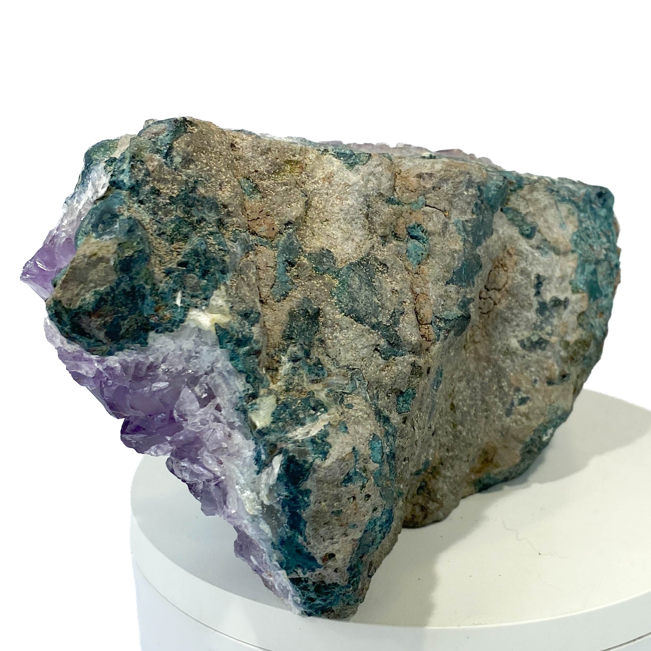 Dark amethyst horizontal standing cluster with small stalactites on white background
