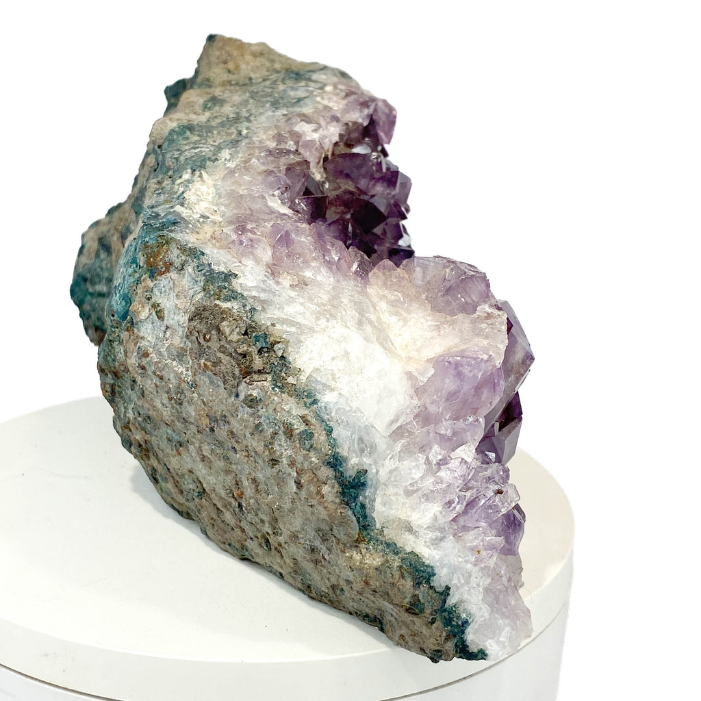 Dark amethyst horizontal standing cluster with small stalactites on white background
