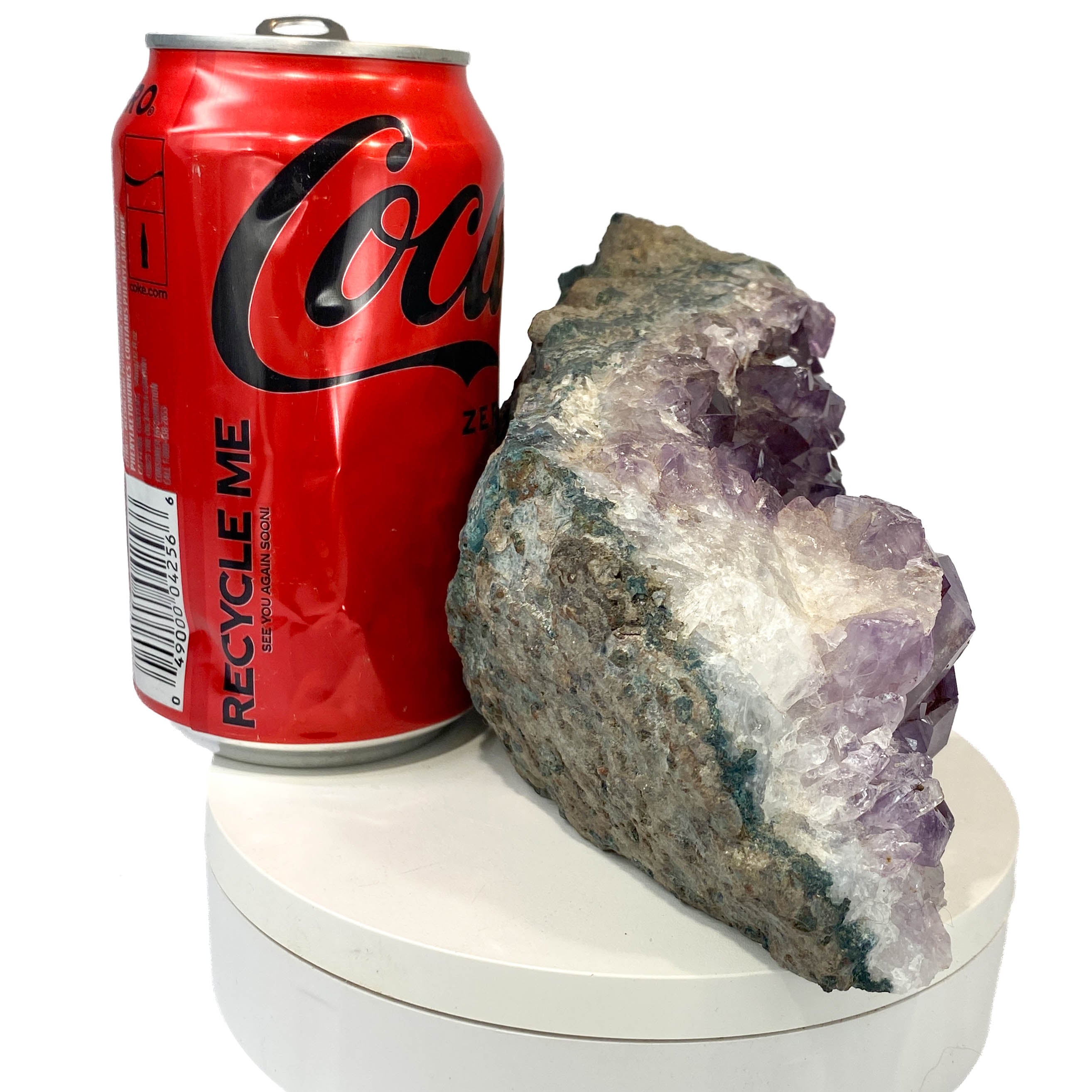 Dark amethyst horizontal standing cluster with small stalactites, a soda can for scale