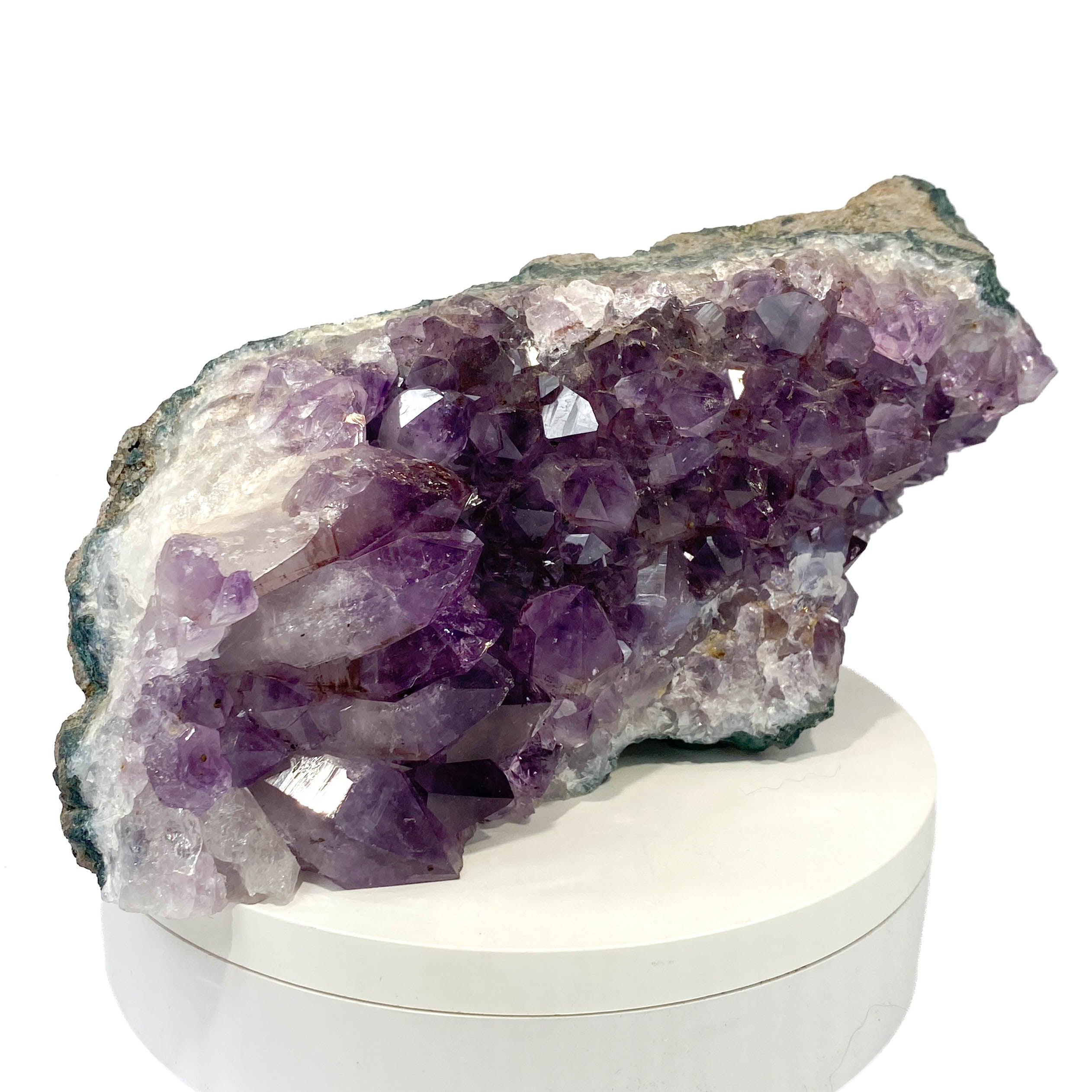 Dark amethyst horizontal standing cluster with small stalactites on white background