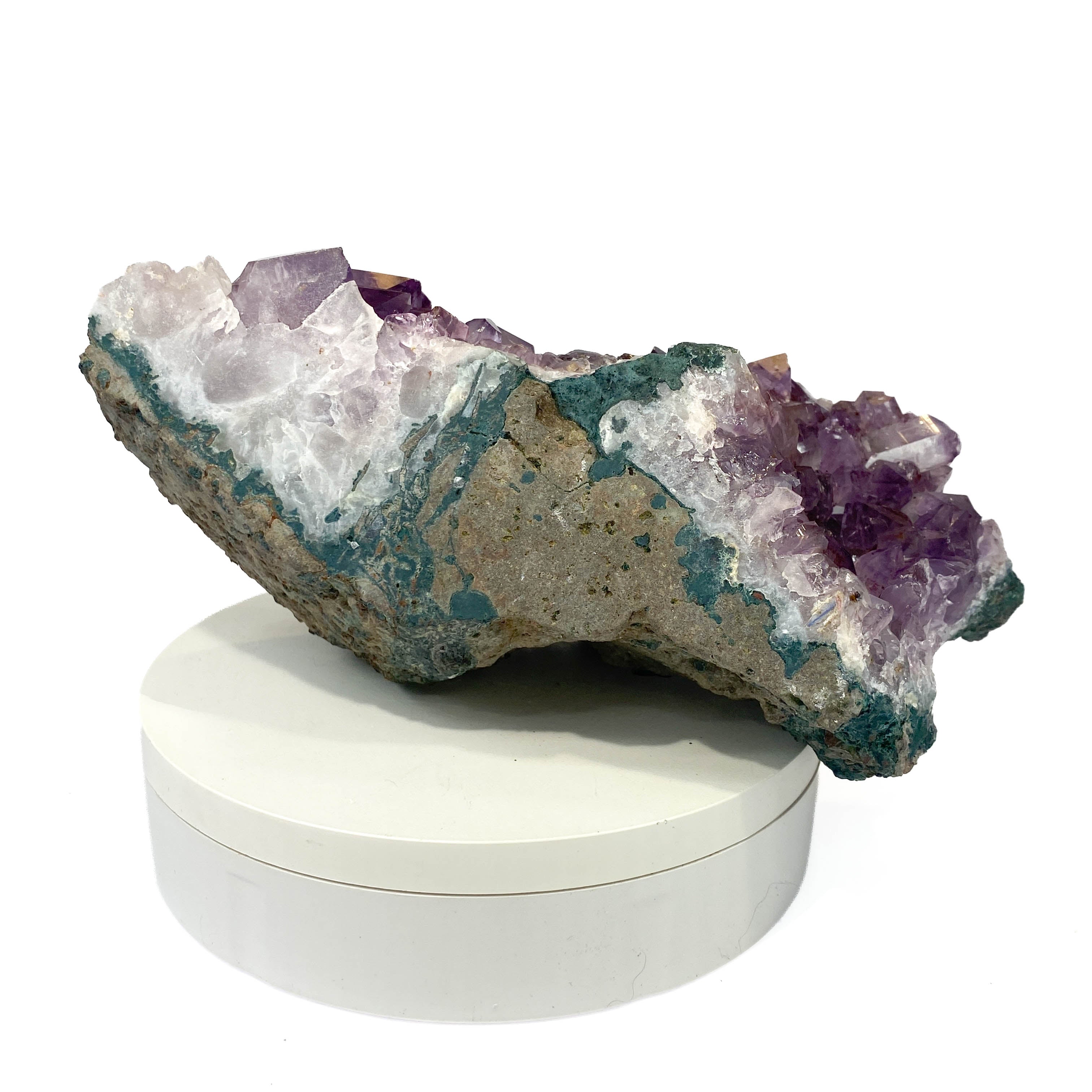 Dark amethyst horizontal standing cluster with small stalactites on white background