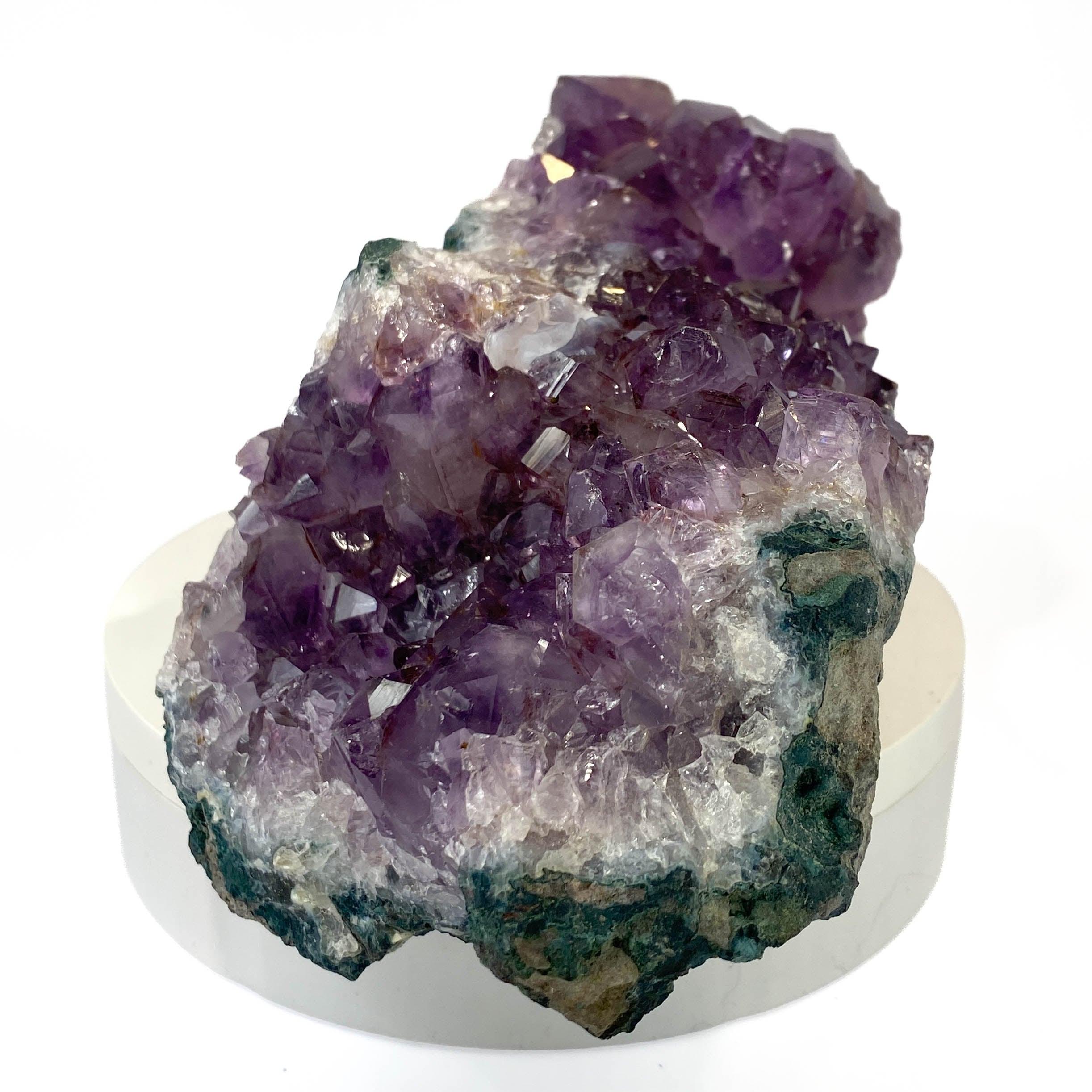 Dark amethyst horizontal standing cluster with small stalactites on white background