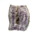 Amethyst geode cross section with clear crystal delineation on white background