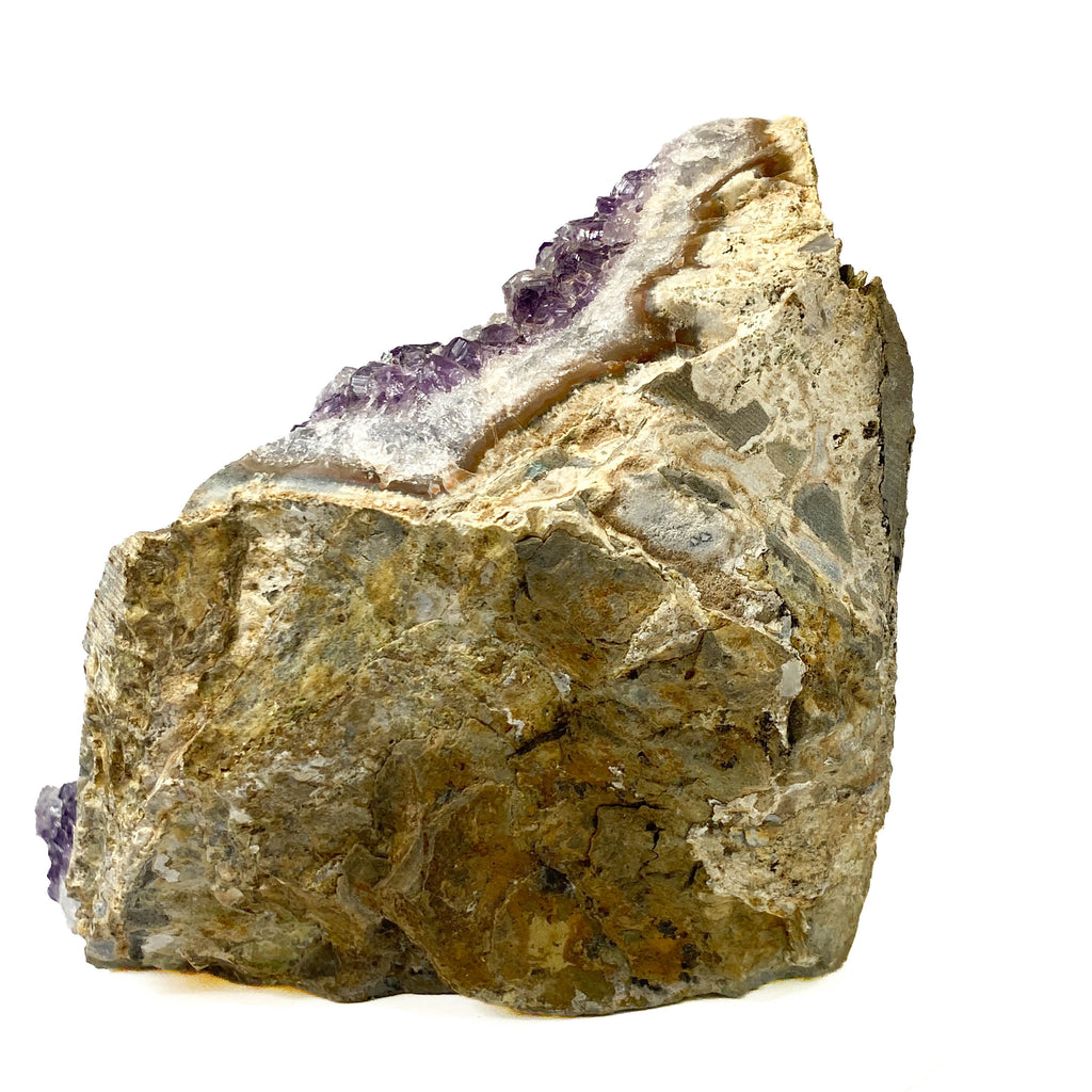 Standing angel-shaped amethyst cluster with dark crystals and phantoms on white background