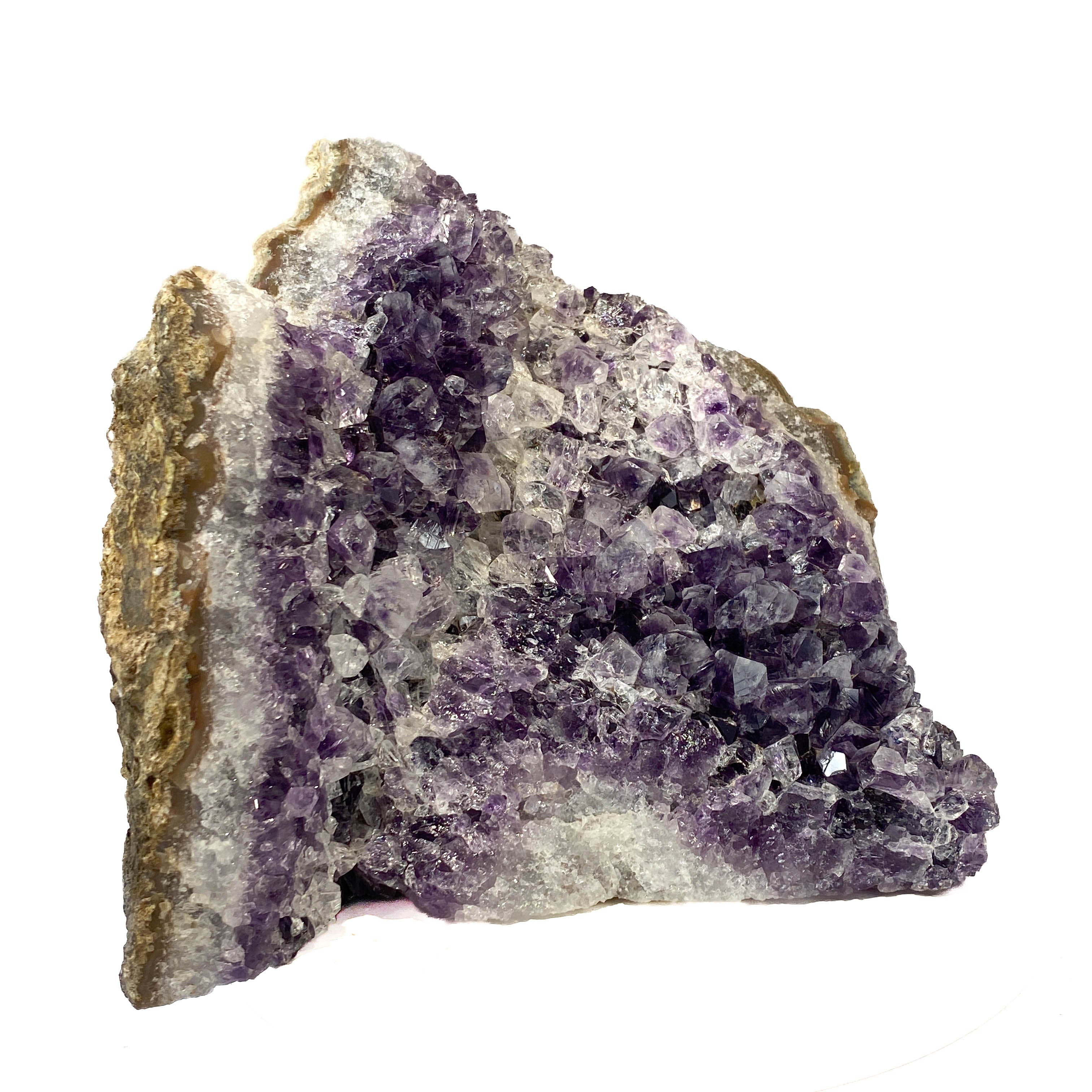 Standing angel-shaped amethyst cluster with dark crystals and phantoms on white background