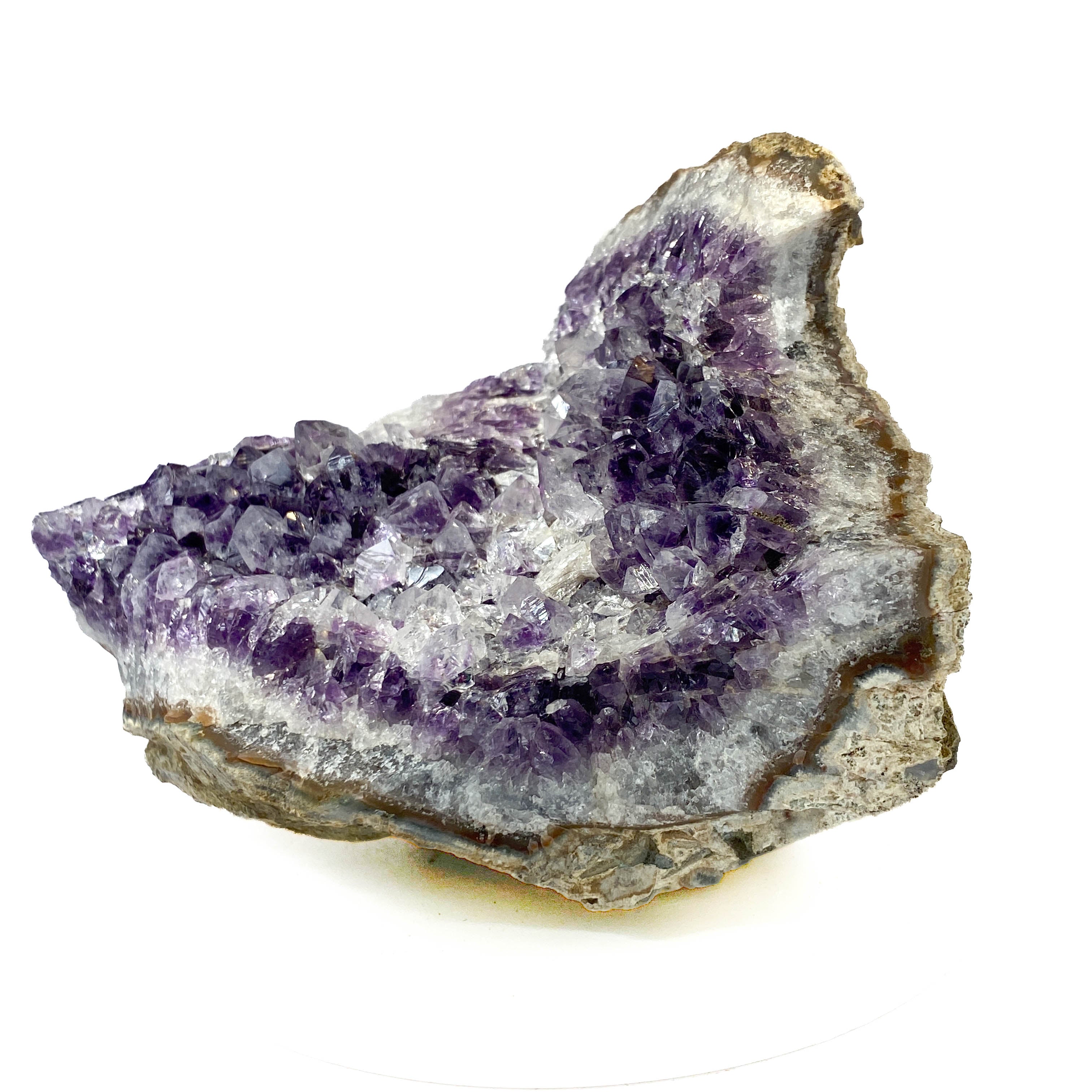 Standing angel-shaped amethyst cluster with dark crystals and phantoms on white background