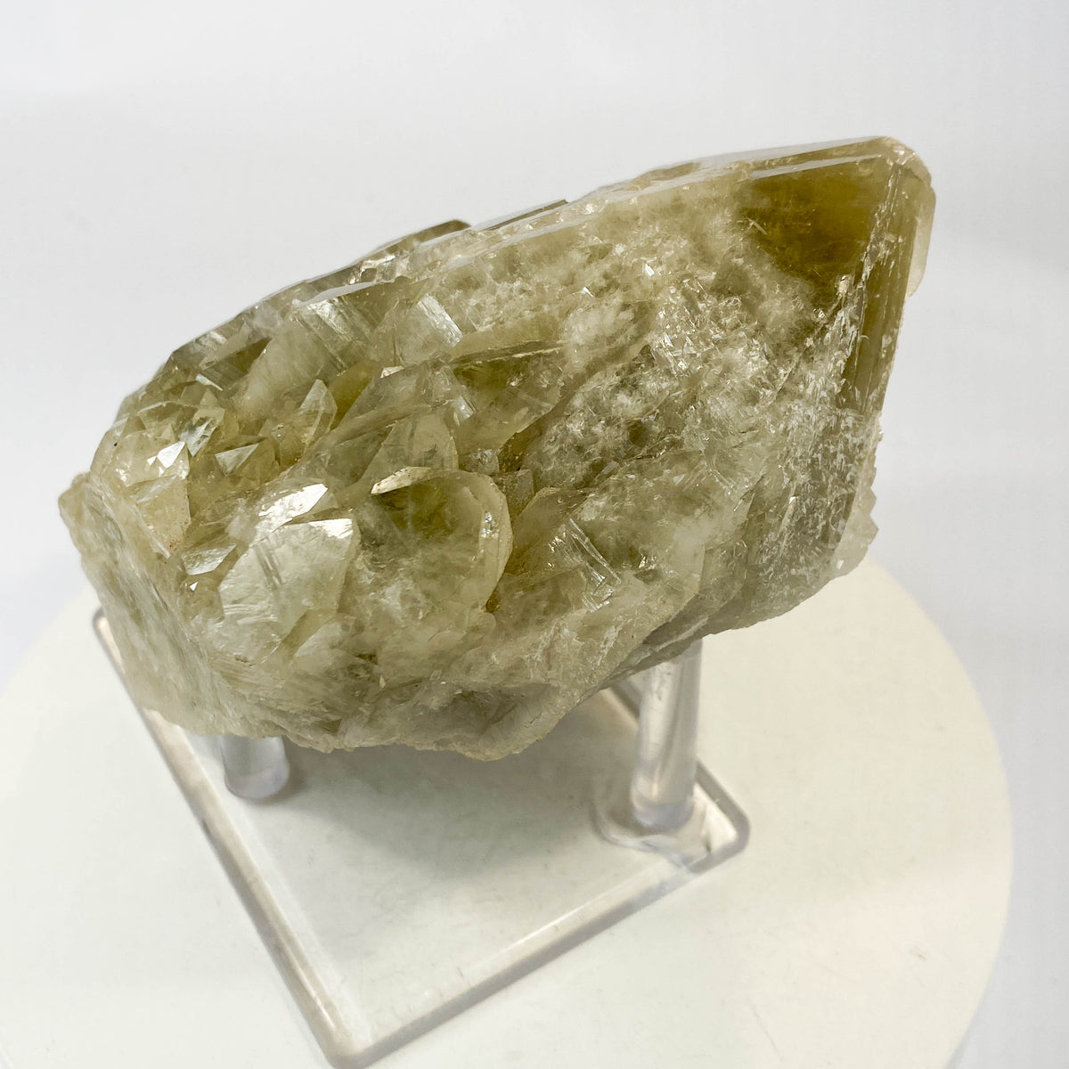 Elestial smoky citrine candle quartz point with daughter crystals on white background