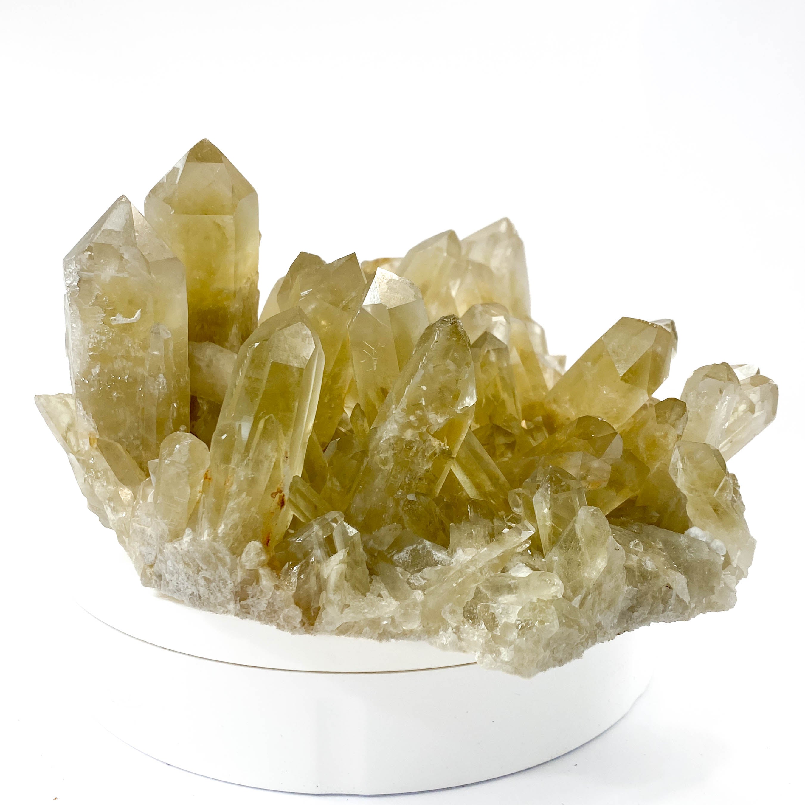 Natural citrine quartz cluster with clear crystal points on white background