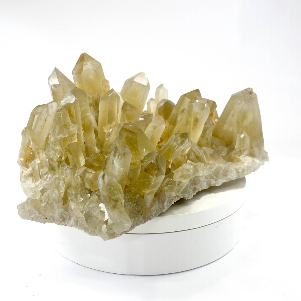 Natural citrine quartz cluster with clear crystal points on white background