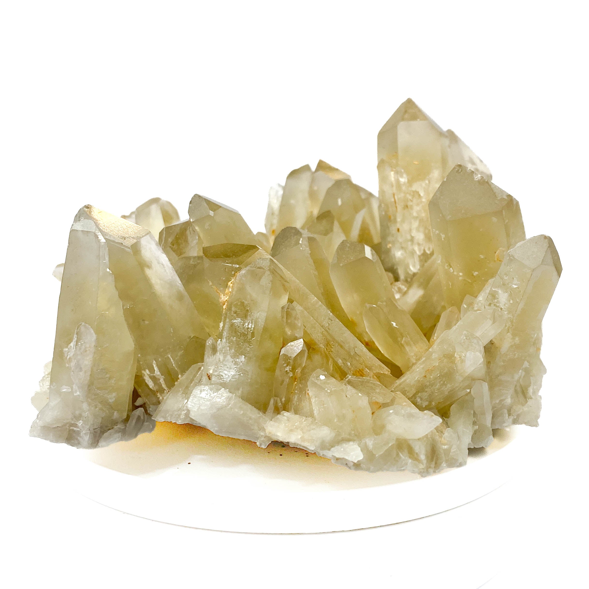 Natural citrine quartz cluster with clear crystal points on white background
