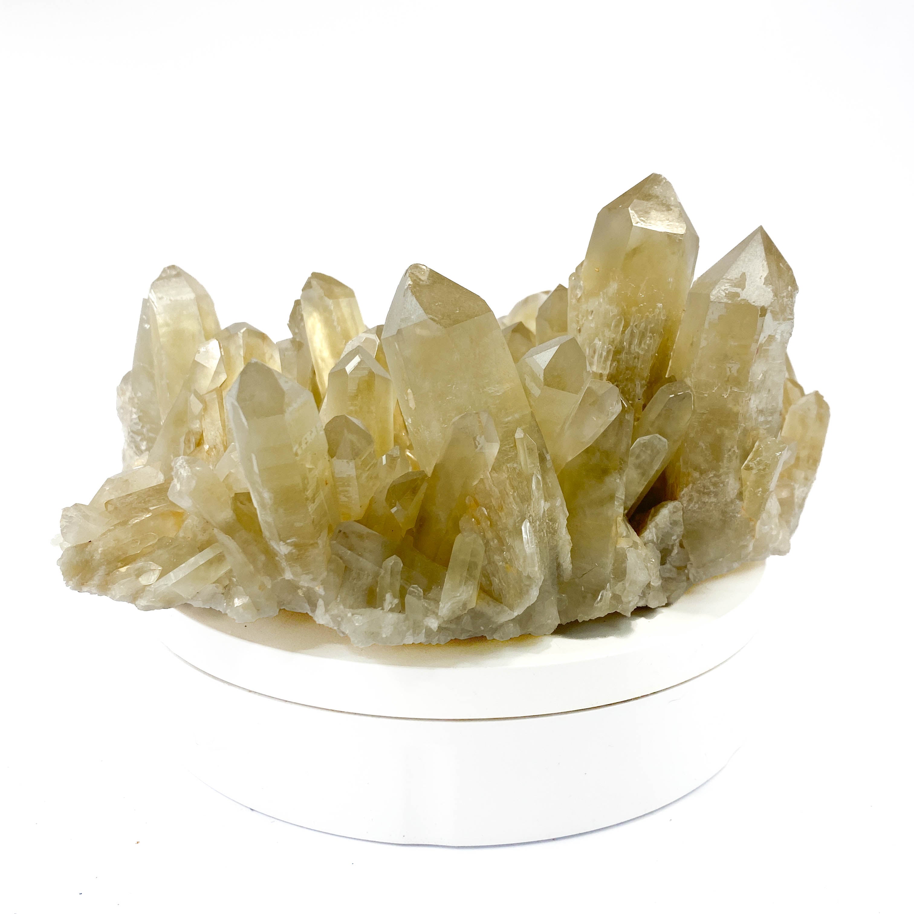 Natural citrine quartz cluster with clear crystal points on white background