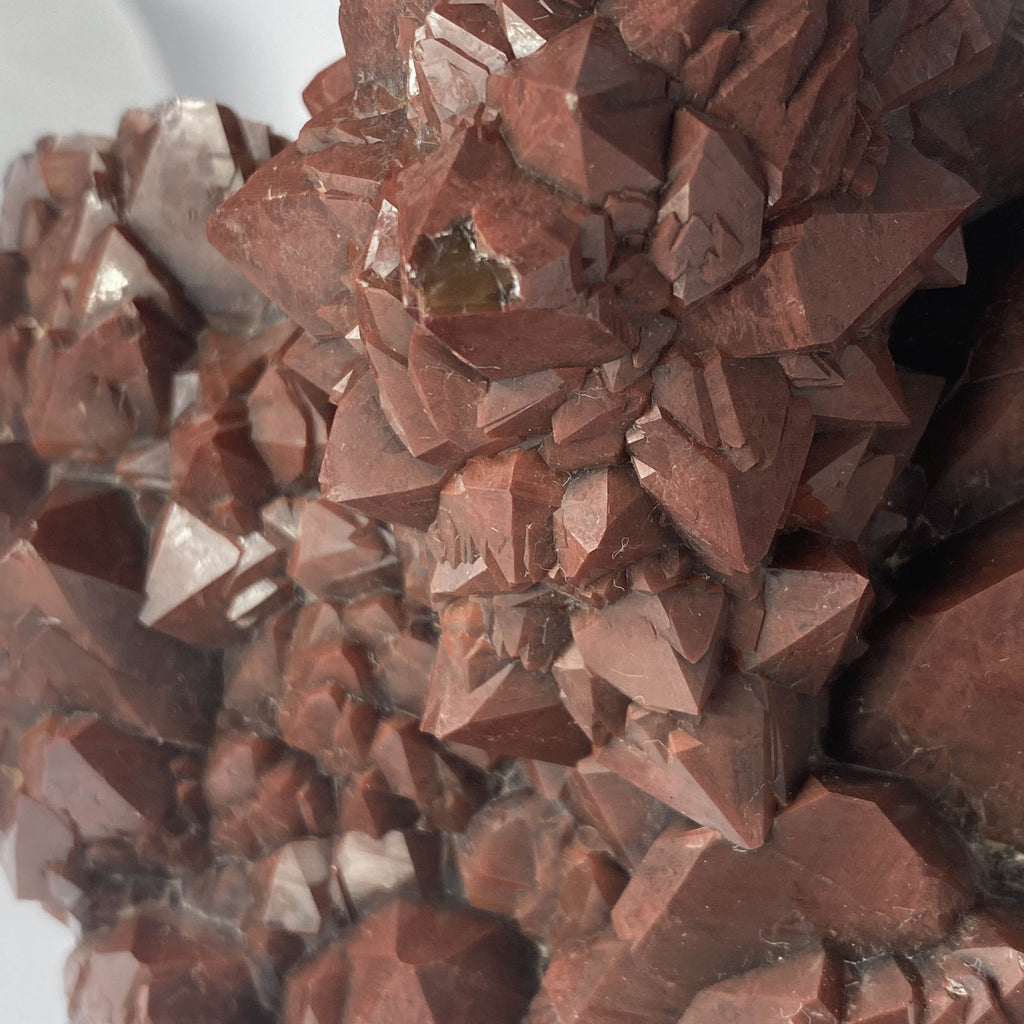 Close-up of small chip on backside of hematoid quartz crystal point