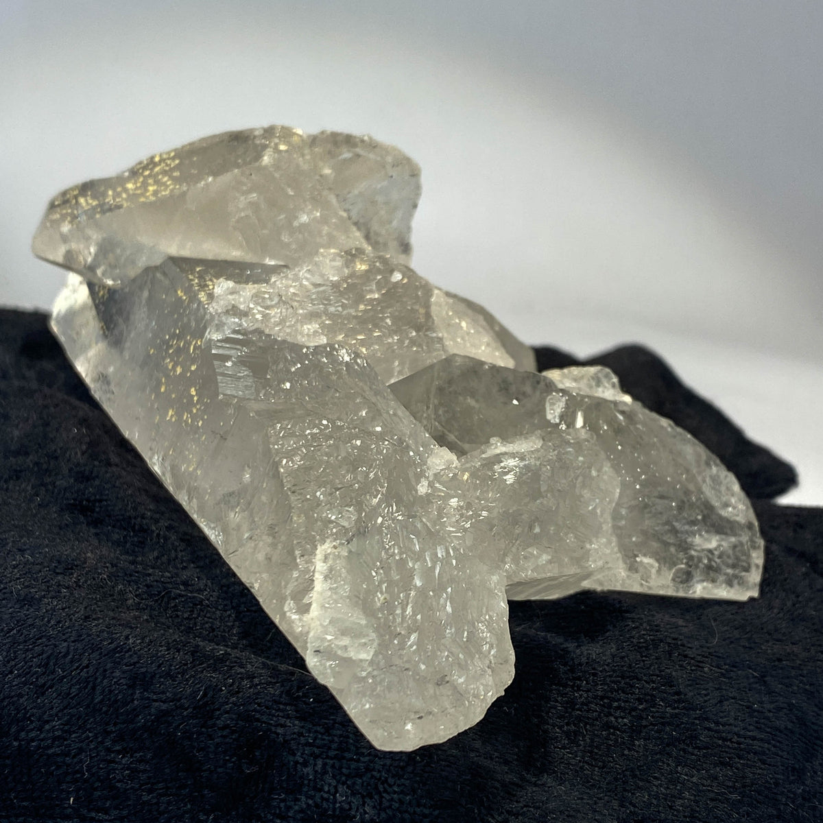 Waterclear quartz crystalline aggregate cluster on white background