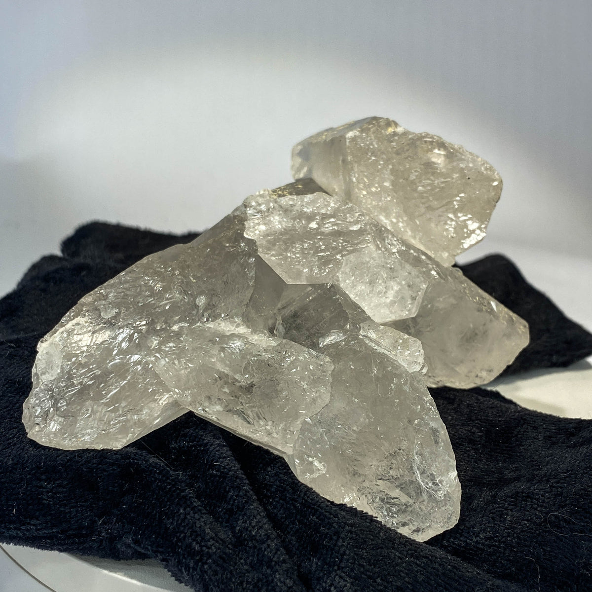 Waterclear quartz crystalline aggregate cluster on white background
