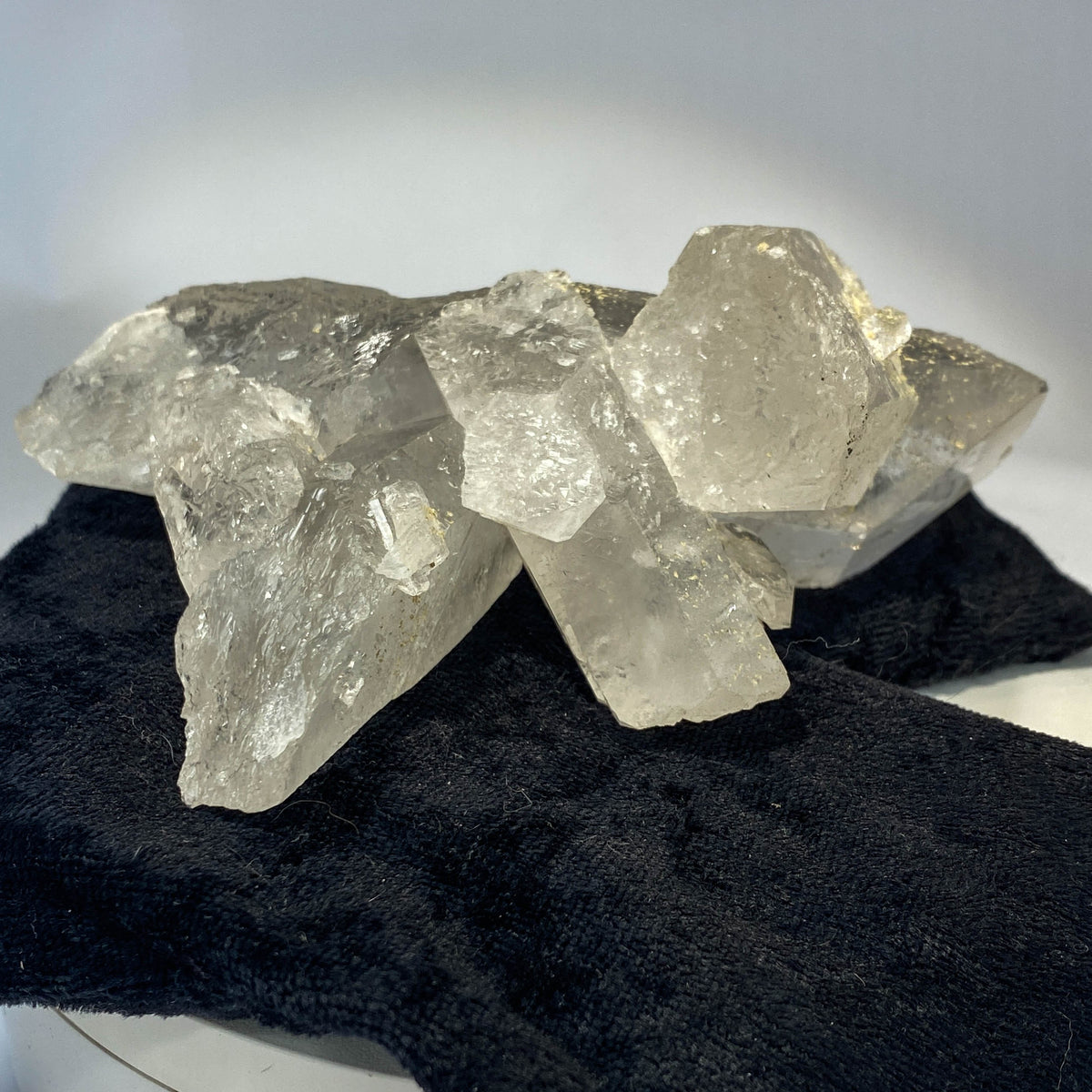Waterclear quartz crystalline aggregate cluster on white background