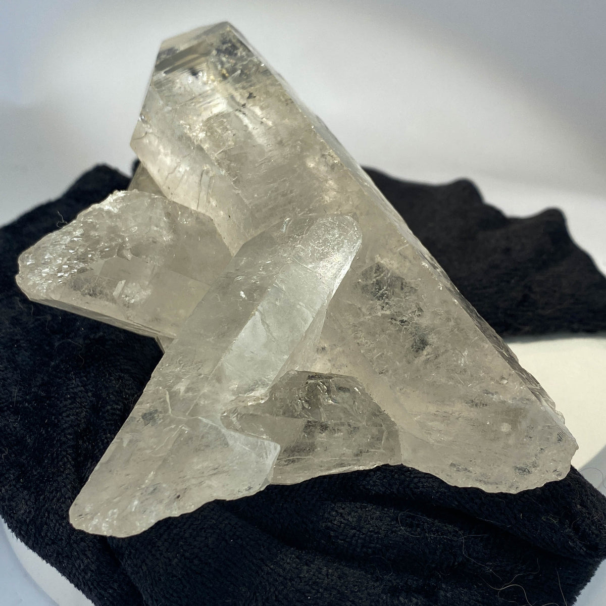 Waterclear quartz crystalline aggregate cluster on white background