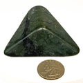 Carved Washington jade triangle with tree pattern on white background