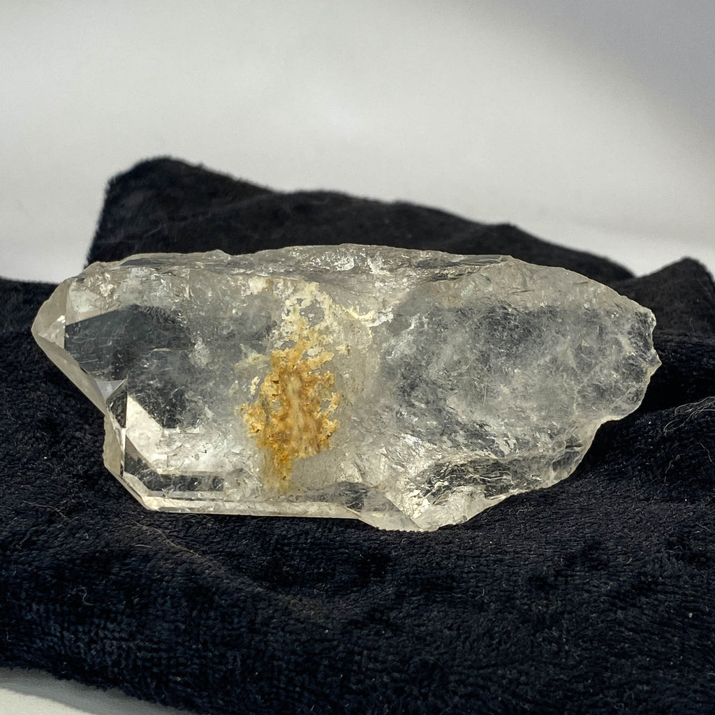 Tantric twin quartz crystal with rainbow refractions on black cloth background
