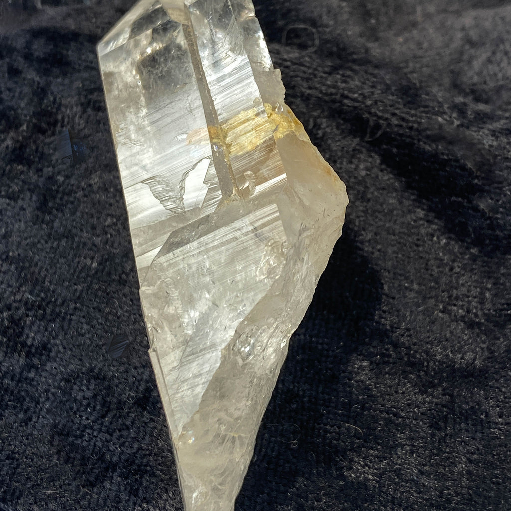 Tantric twin quartz crystal with rainbow refractions on black cloth background