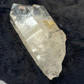 Tantric twin quartz crystal with rainbow refractions on black cloth background