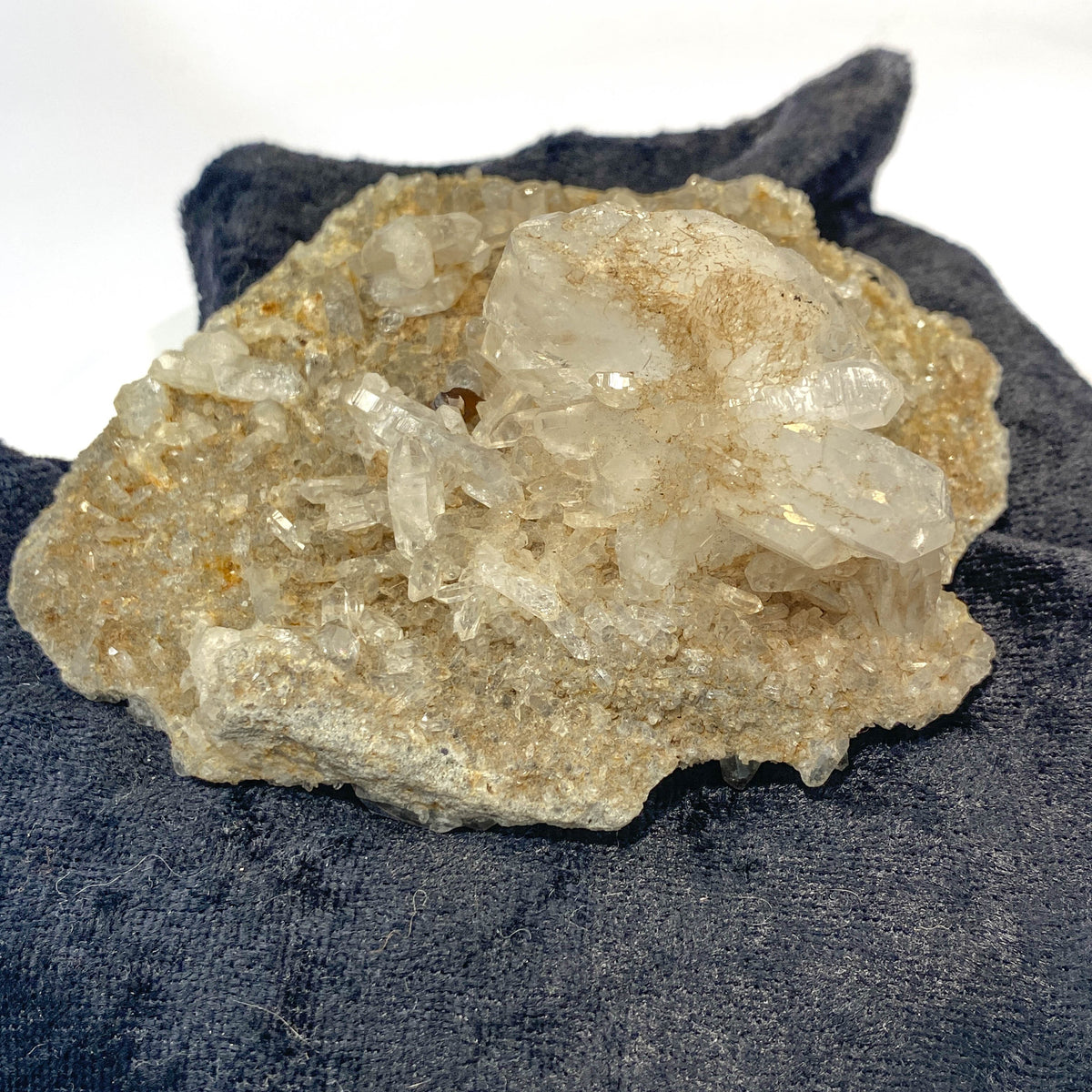 Double-sided quartz plate with clear crystal cluster on dark cloth background